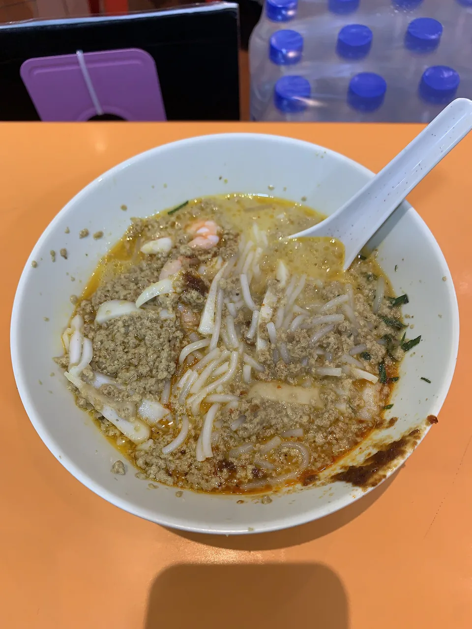 Semangkuk laksa berkuah merah dengan santan