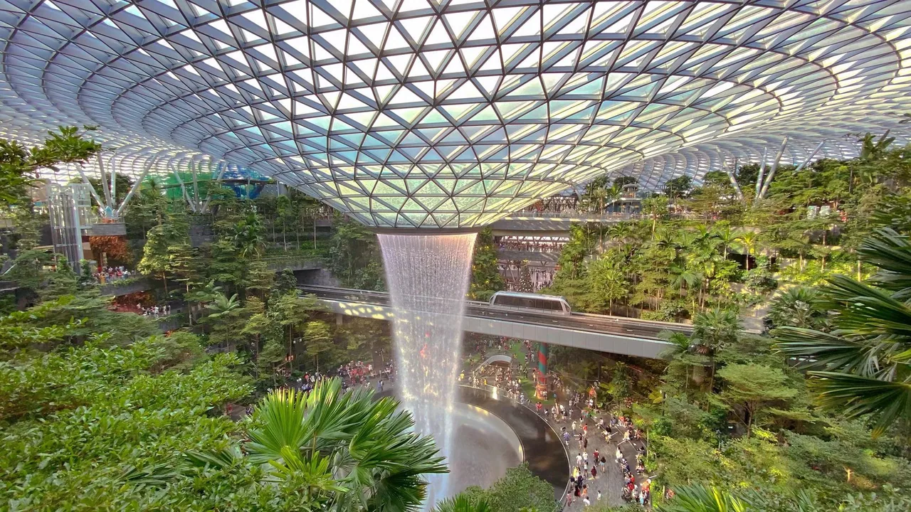 Inside the glass dome of Jewel Changi Airport, with the Rain Vortex and Forest Valley Inside the glass dome of Jewel Changi Airport, with the Rain Vortex and Forest Valley
