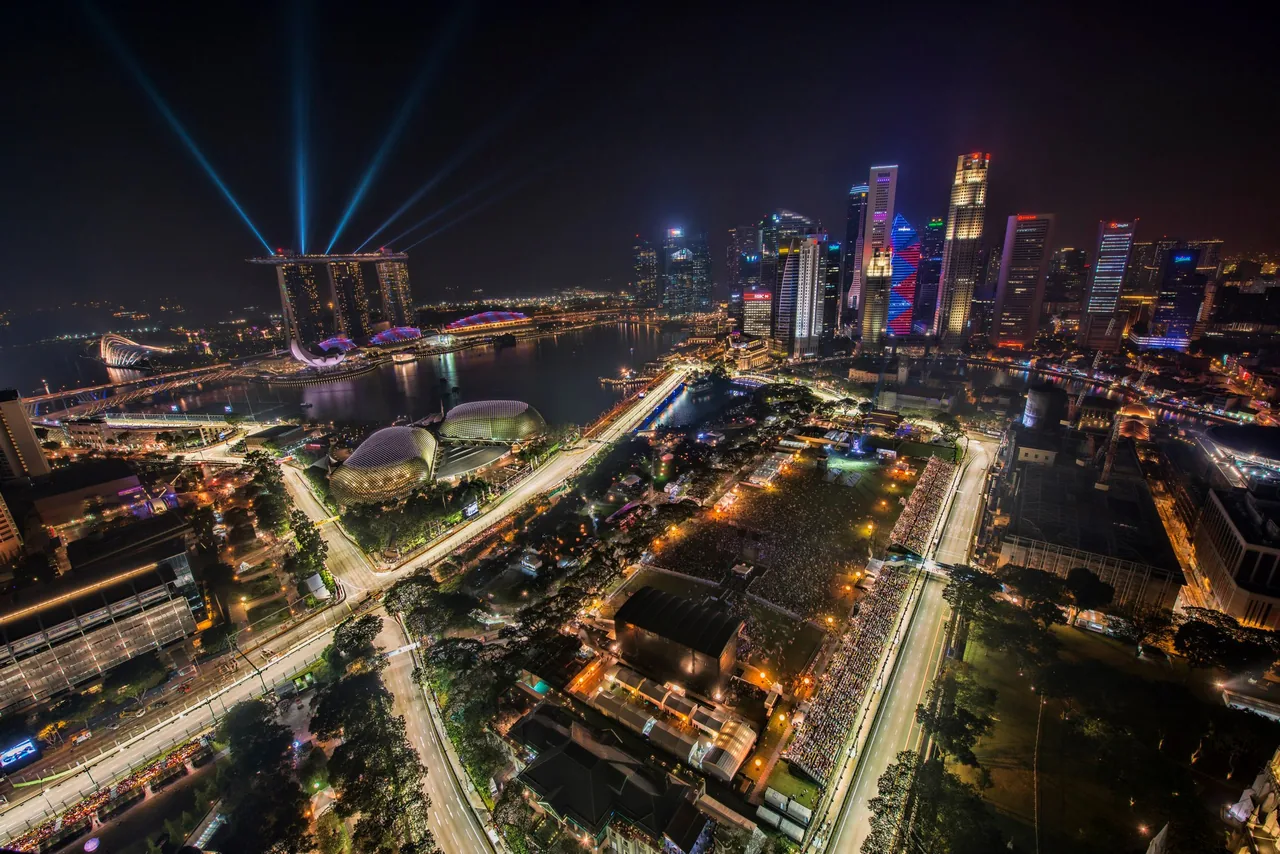 Aerial night view of the floodlit Marina Bay Street Circuit winding through downtown Singapore