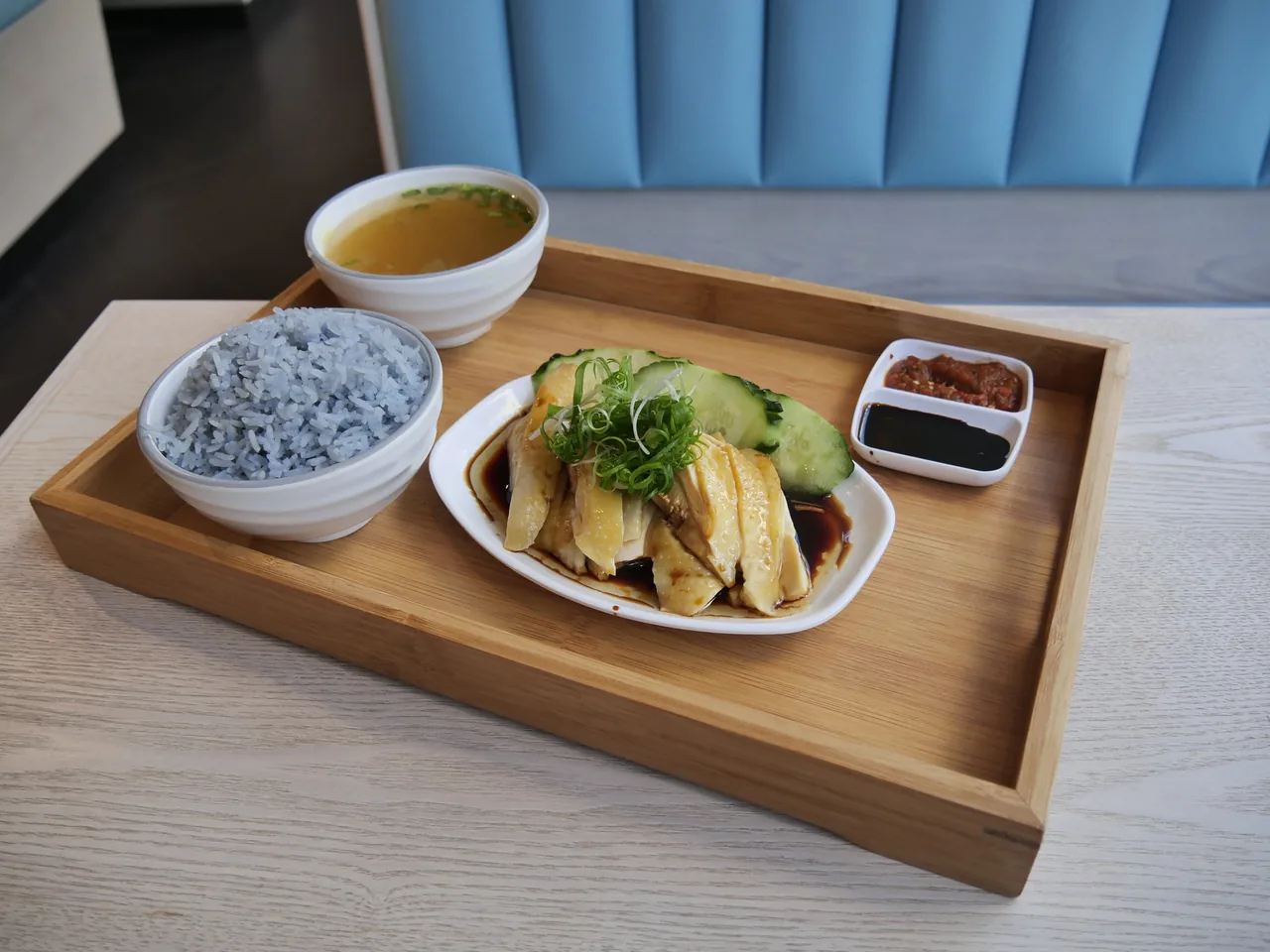 A plate of Hainanese chicken rice with rice, soup and chilli sauce, Singapore