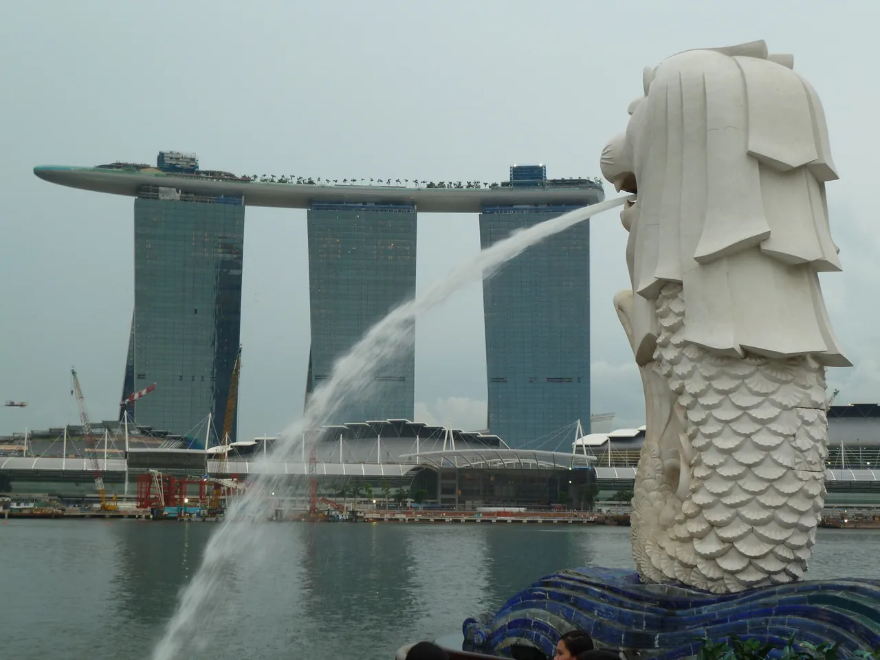 The Merlion statue spouting water with Marina Bay Sands behind it