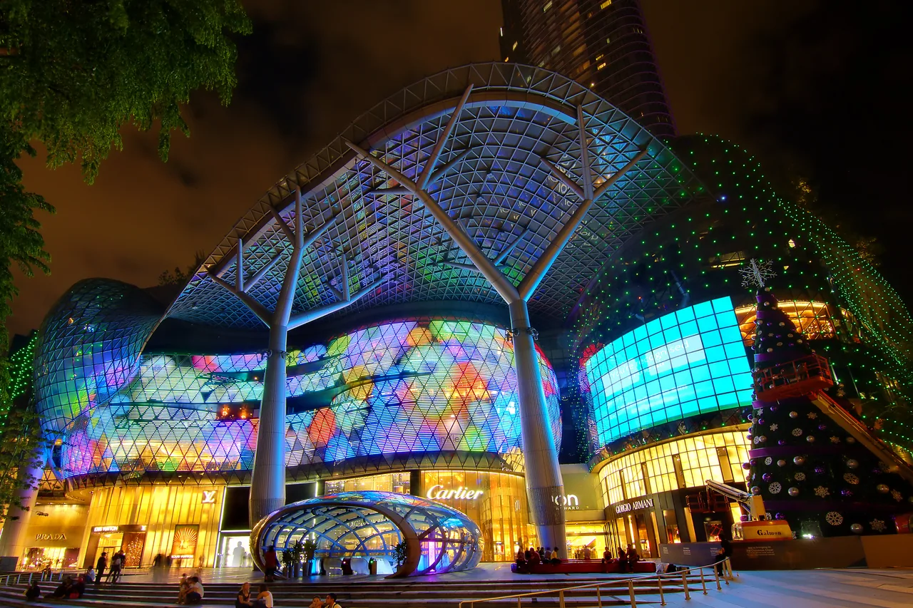 The illuminated facade of ION Orchard mall at night, Singapore