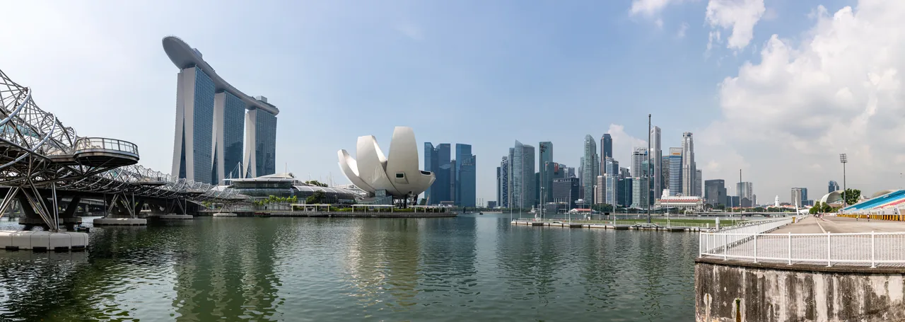 Marina Bay Singapore skyline by day with tropical clouds, typical of a bright July morning