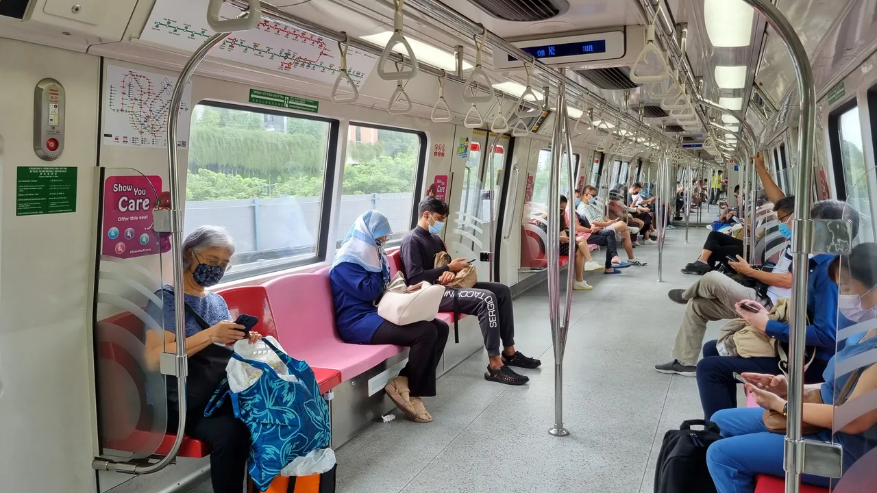 A Singapore MRT train at a platform, the cheapest way from Changi to the city