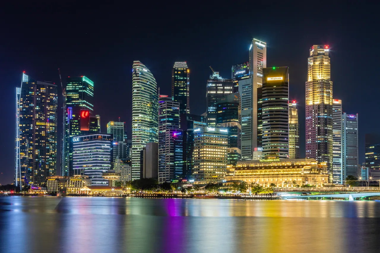 The Marina Bay skyline in Singapore glowing at night across the water