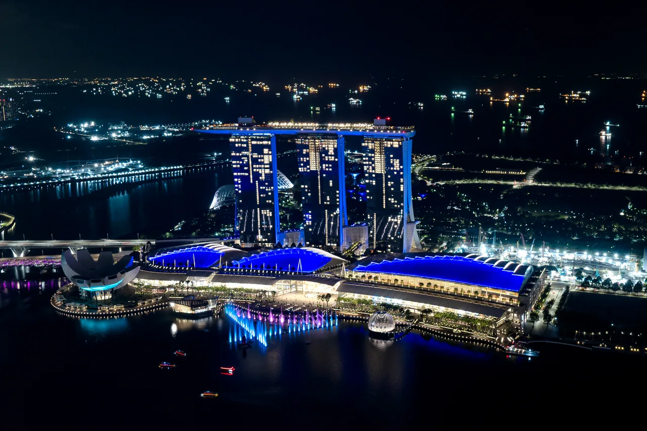 The Spectra light and water show in front of Marina Bay Sands at night The Spectra light and water show in front of Marina Bay Sands at night