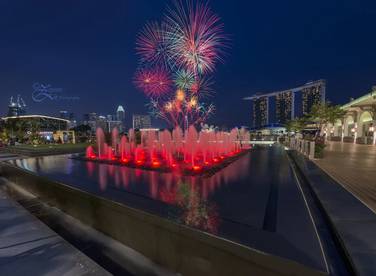 Fireworks bursting over the Marina Bay skyline during a Singapore National Day Parade