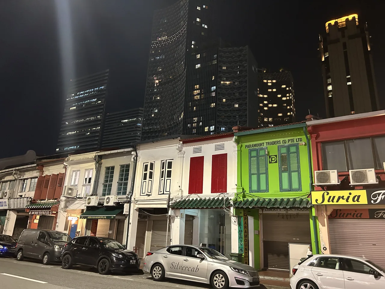 A row of colourful heritage shophouses in Singapore's Arab Street and Haji Lane quarter at night