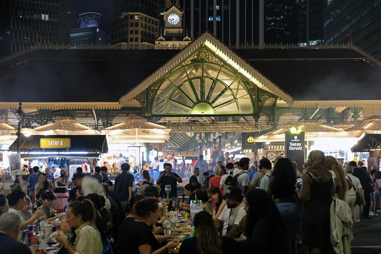 A Singapore hawker centre and food street busy with diners late at night
