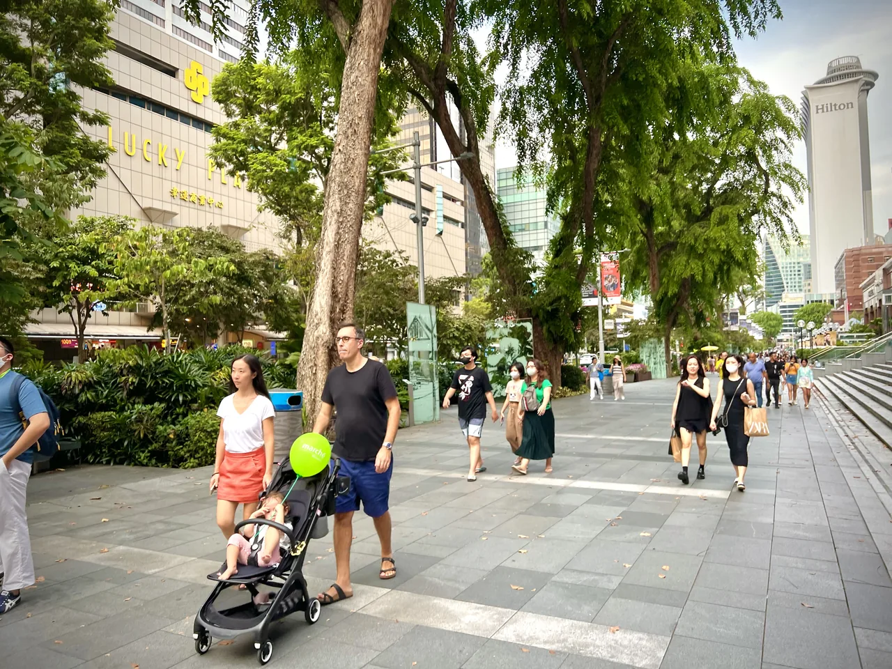 The shopping malls, trees and crowds of Orchard Road, Singapore's famous shopping street