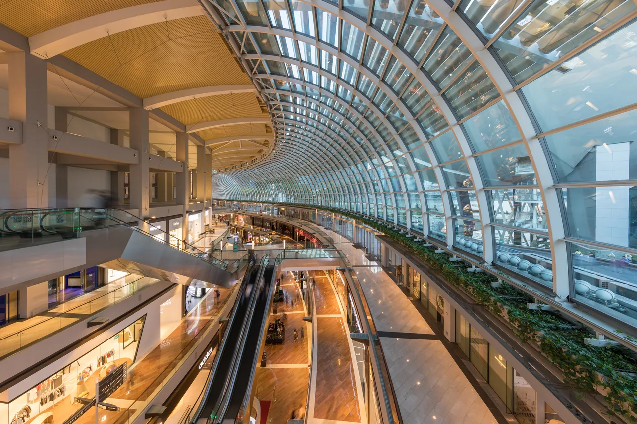 The bright, climate-controlled interior of The Shoppes at Marina Bay Sands mall