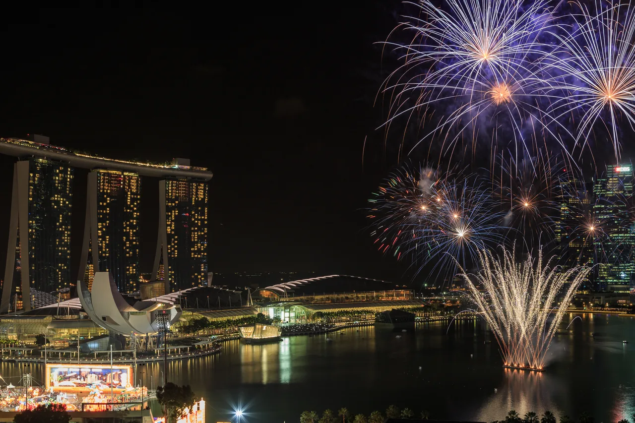 Kembang api meledak di atas Marina Bay Sands dan siluet kota Singapura