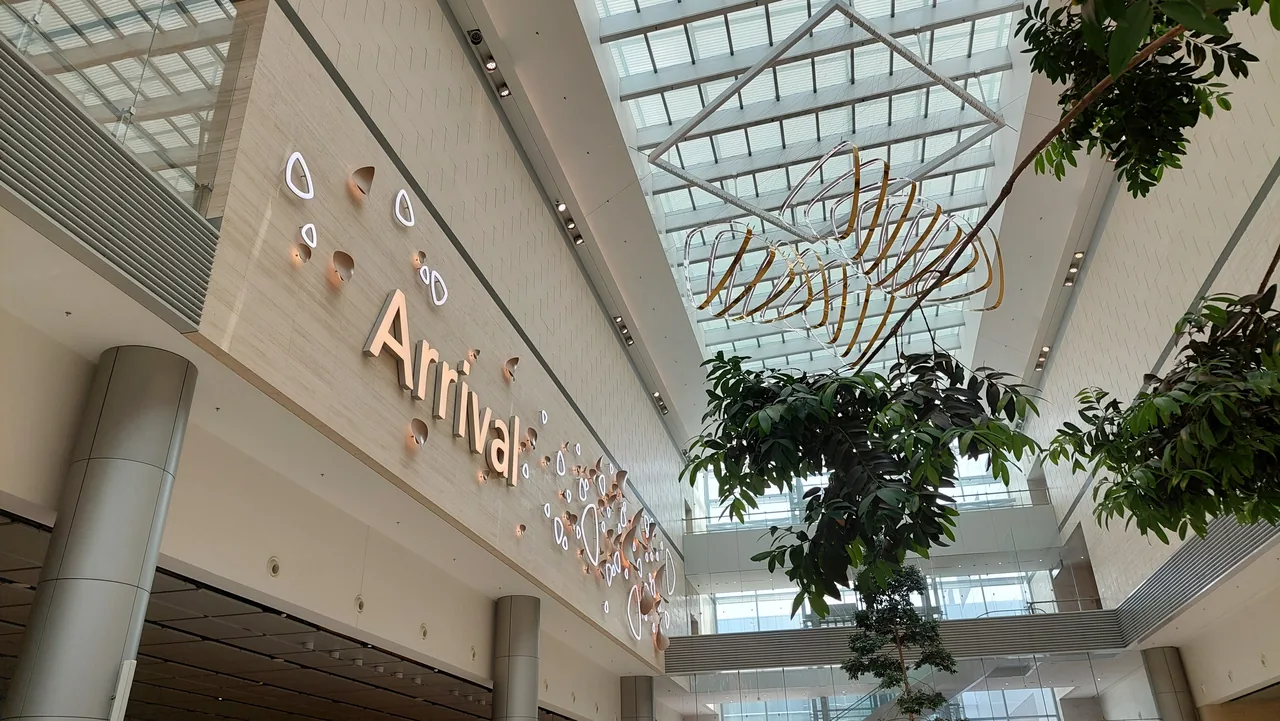 The arrival hall at Changi Airport Terminal 4, where the immigration area sits below the sign The arrival hall at Changi Airport Terminal 4, where the immigration area sits below the sign