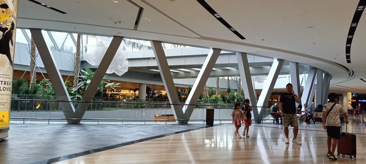 The landside atrium at Jewel Changi Airport with travellers walking through