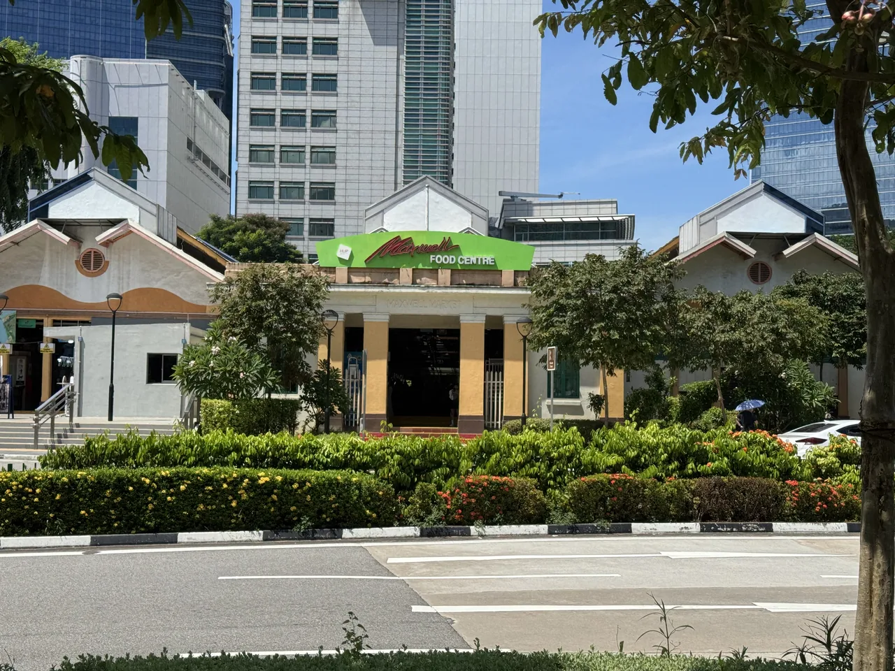 Maxwell Food Centre seen from the street with CBD towers behind it