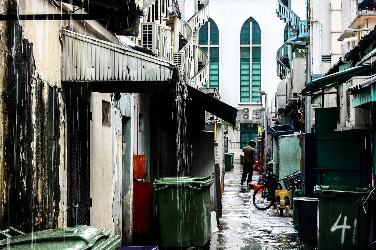 Heavy rain falling on a quiet back lane in Singapore