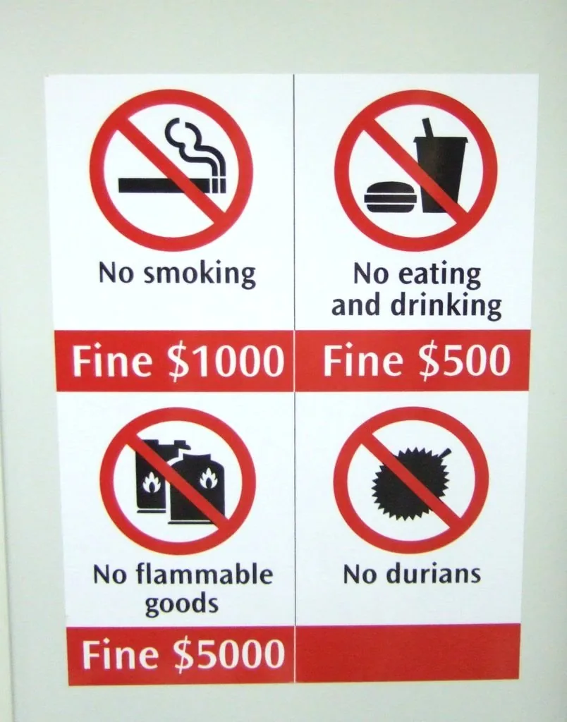 A Singapore MRT sign listing fines for smoking, eating and drinking, flammable goods and durians