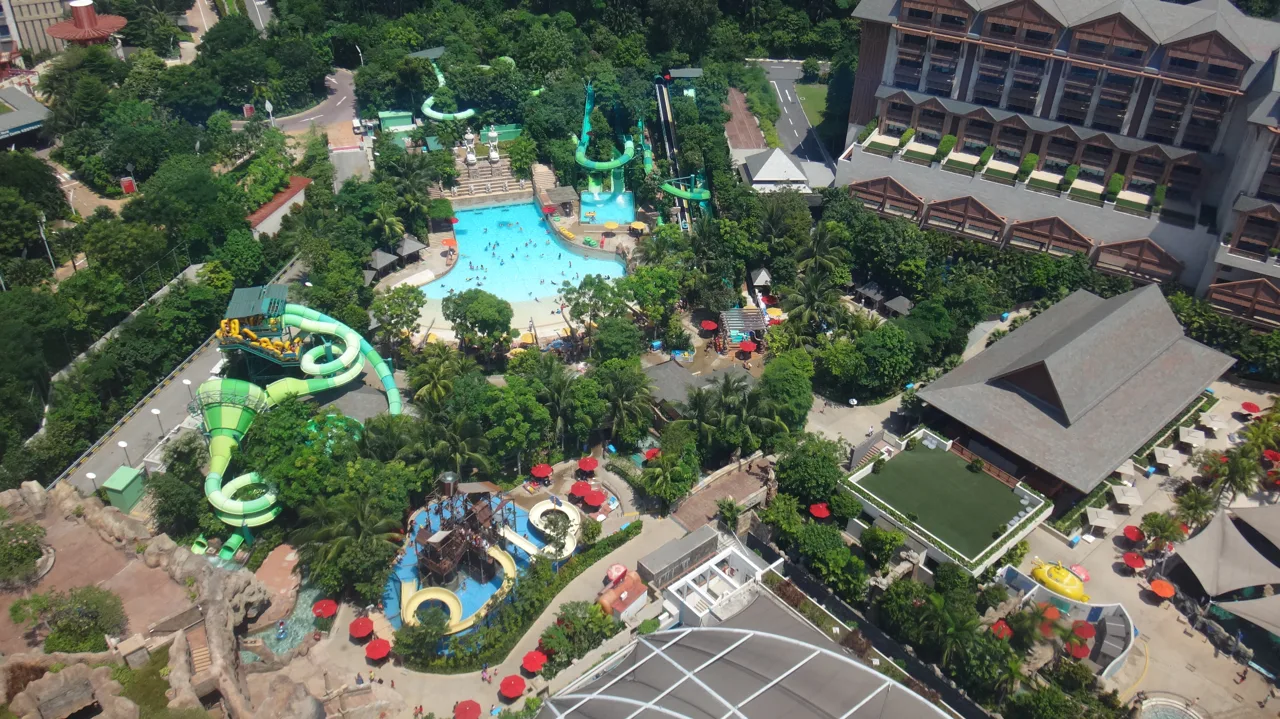 Aerial view of Adventure Cove Waterpark showing the wave pool, yellow and green slides and red parasols