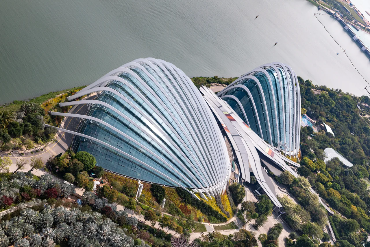 The two glass conservatories of Gardens by the Bay seen from directly above, with water beyond