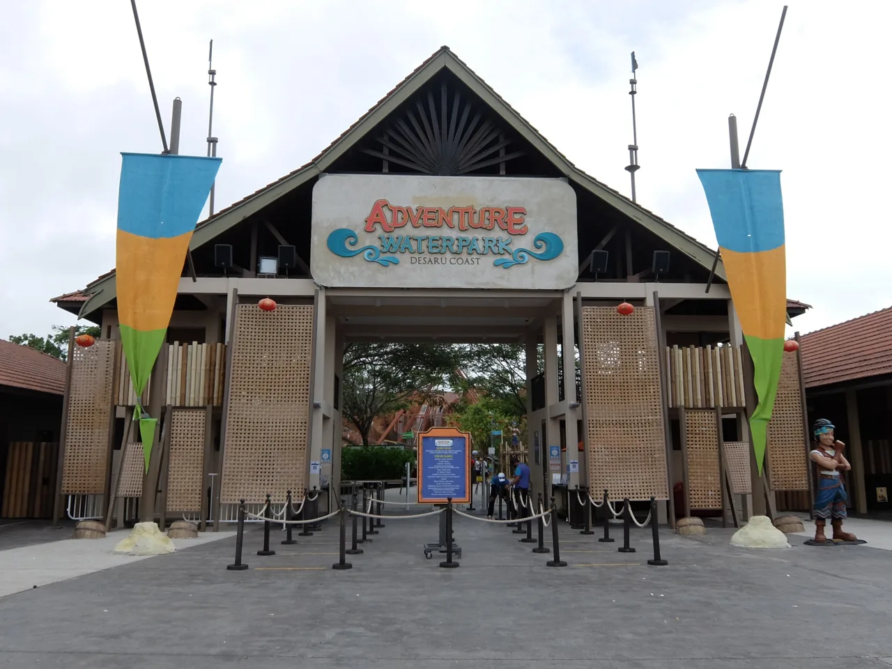 The timber entrance building of Adventure Waterpark Desaru Coast with its sign and empty queue barriers