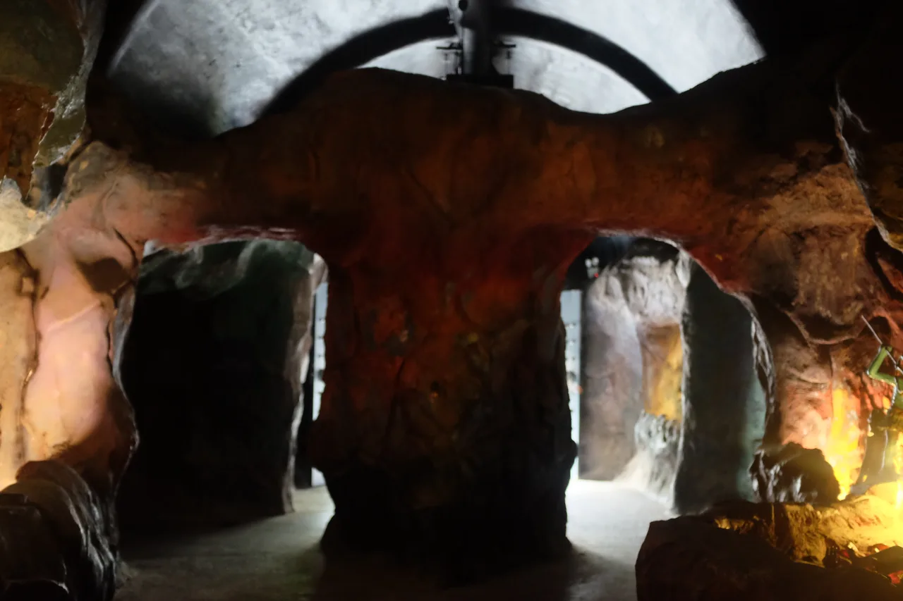 A dim cave like corridor inside the Ten Courts of Hell branching into side chambers