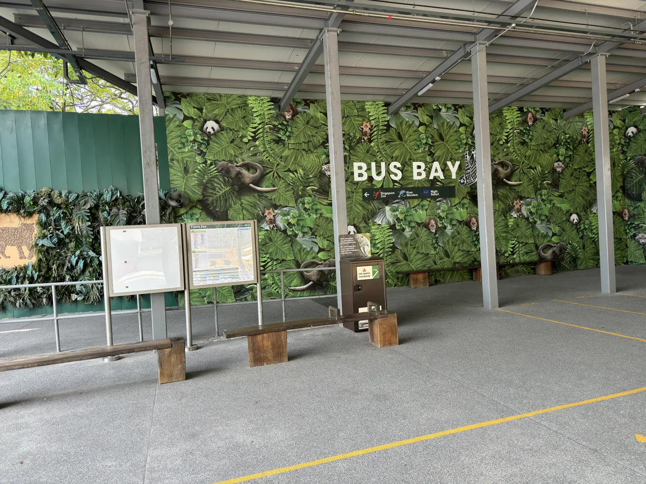 A covered bus bay at Mandai Wildlife EAST with signage pointing towards Singapore Zoo, River Wonders and Night Safari