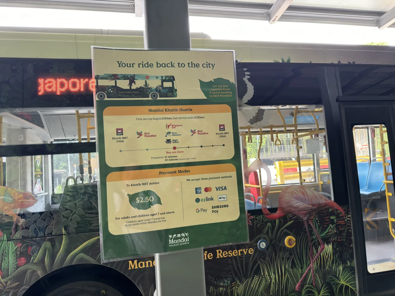 The Mandai Khatib Shuttle information board showing the S$2.50 fare and the accepted payment cards