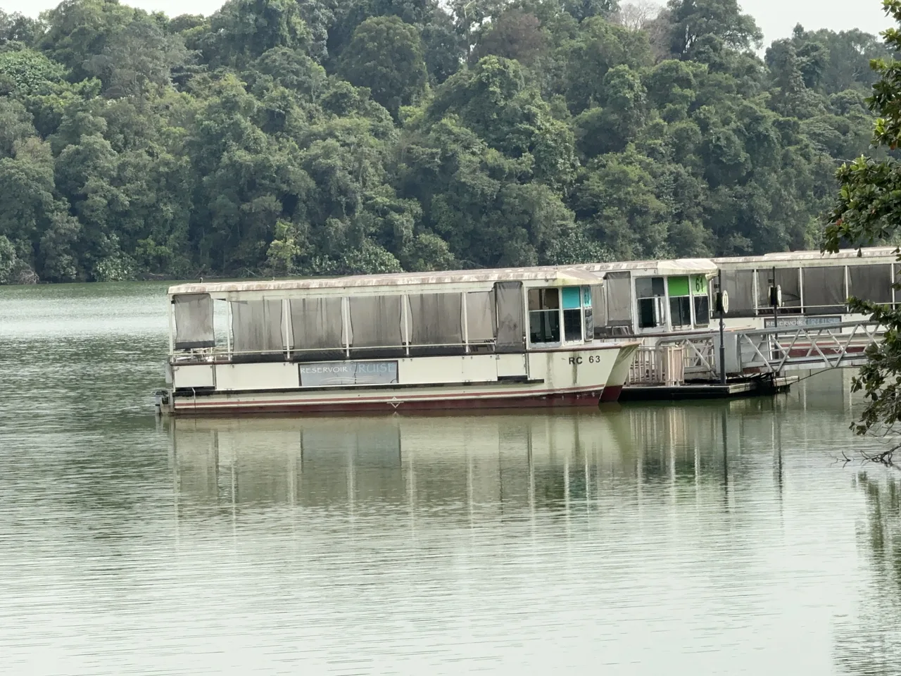 The River Wonders reservoir cruise boat moored at the jetty in front of forested hills
