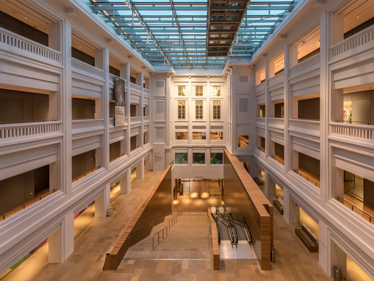 The skylit central hall of the National Gallery Singapore with corridors on four levels
