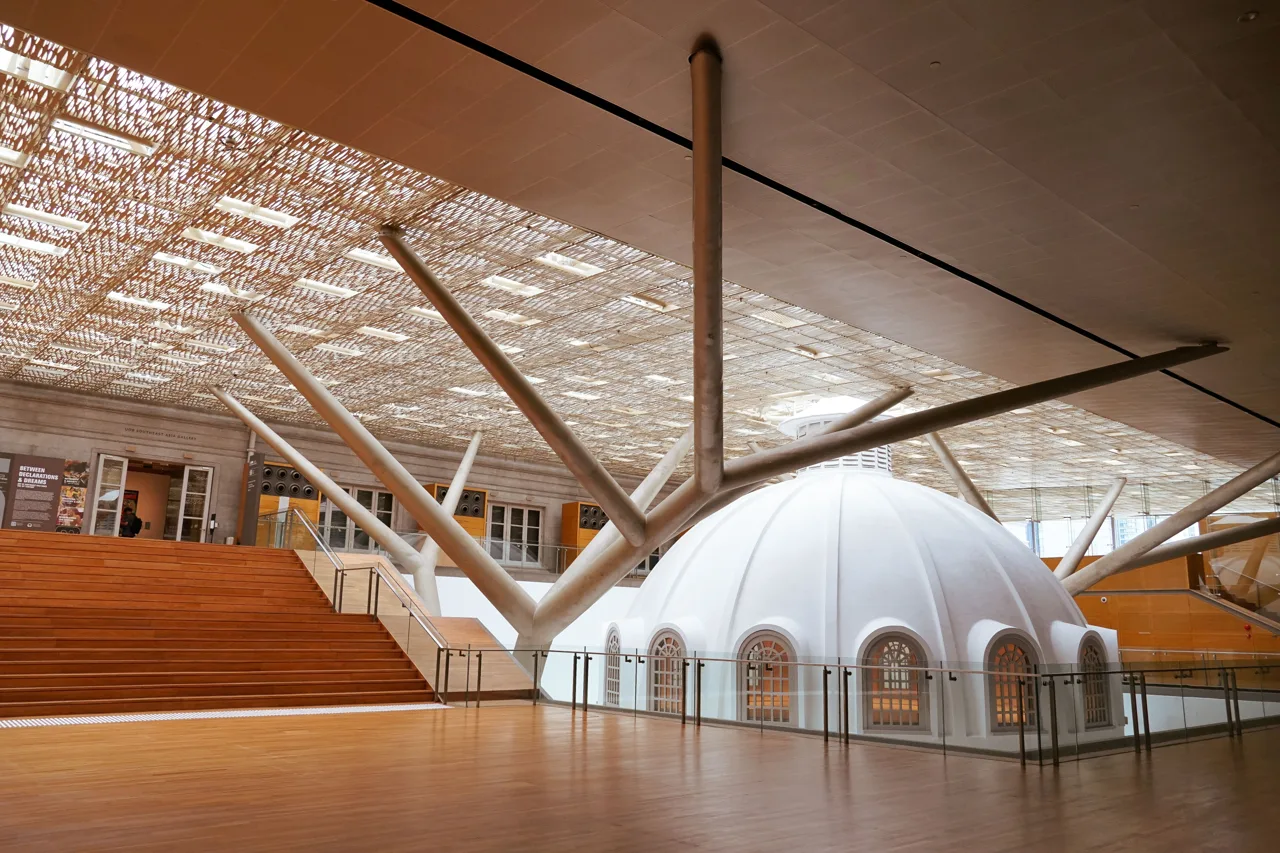 The white dome of the old Supreme Court library standing indoors beneath a perforated roof canopy