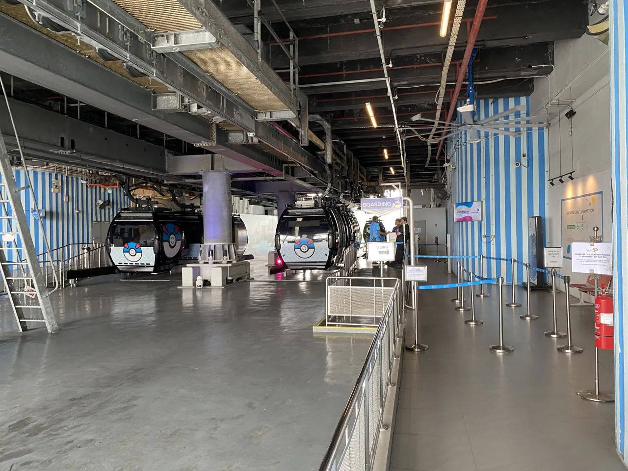 Cable car cabins arriving at the boarding platform inside HarbourFront Cable Car Station