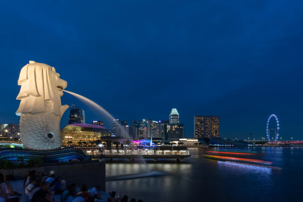 The Merlion statue spouting into Marina Bay with the Esplanade, the financial district and the Singapore Flyer across the water