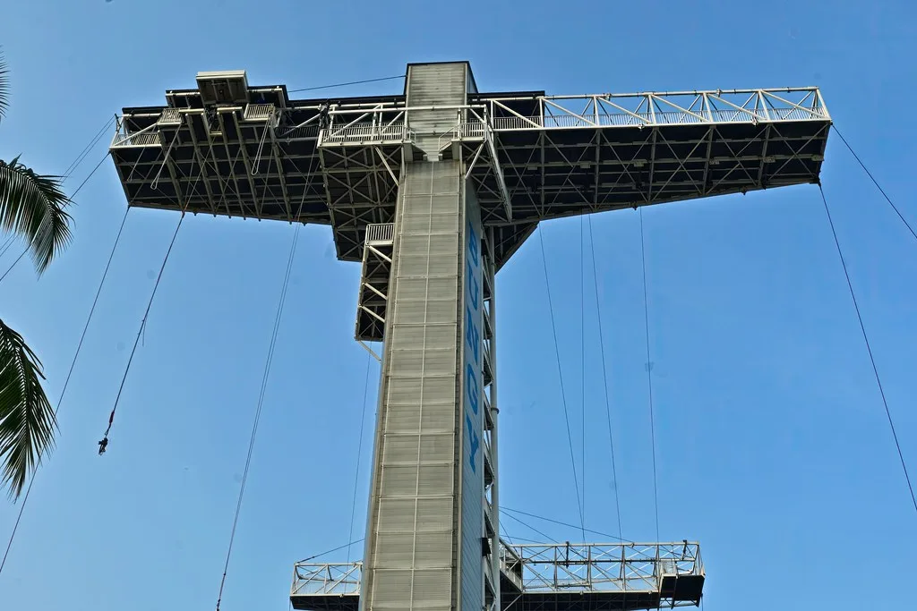 藍天下從底部仰望聖淘沙天空公園的塔，兩側伸出跳臺
