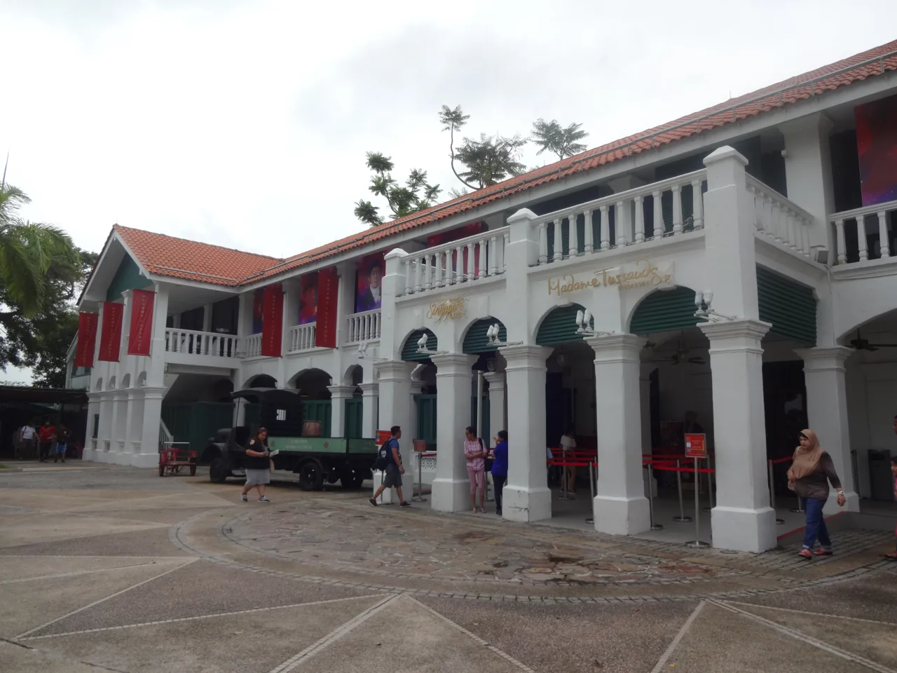 The white colonial-style building housing Madame Tussauds Singapore at Imbiah Lookout, with ticket counters under the arcade