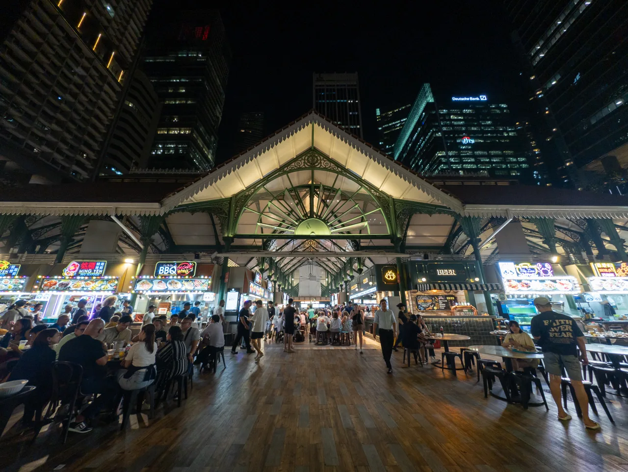 夜に明かりのついたラオパサの入口と食事をする人たち