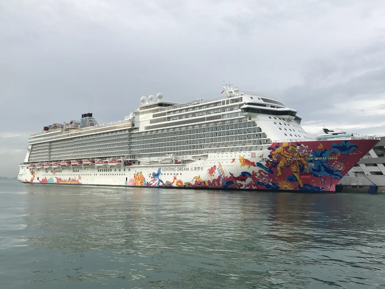 Genting Dream cruise ship with its colourful bow artwork moored at Marina Bay Cruise Centre Singapore