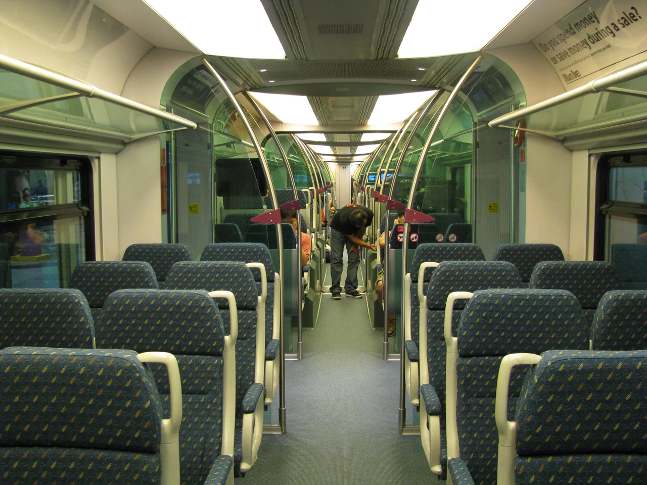 Inside a KLIA Ekspres carriage, with rows of seats and luggage racks