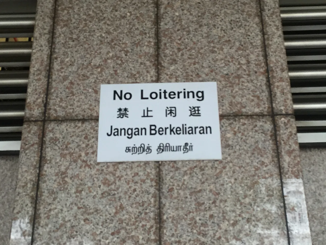 A multilingual notice on the wall of the SMRT headquarters building in Singapore